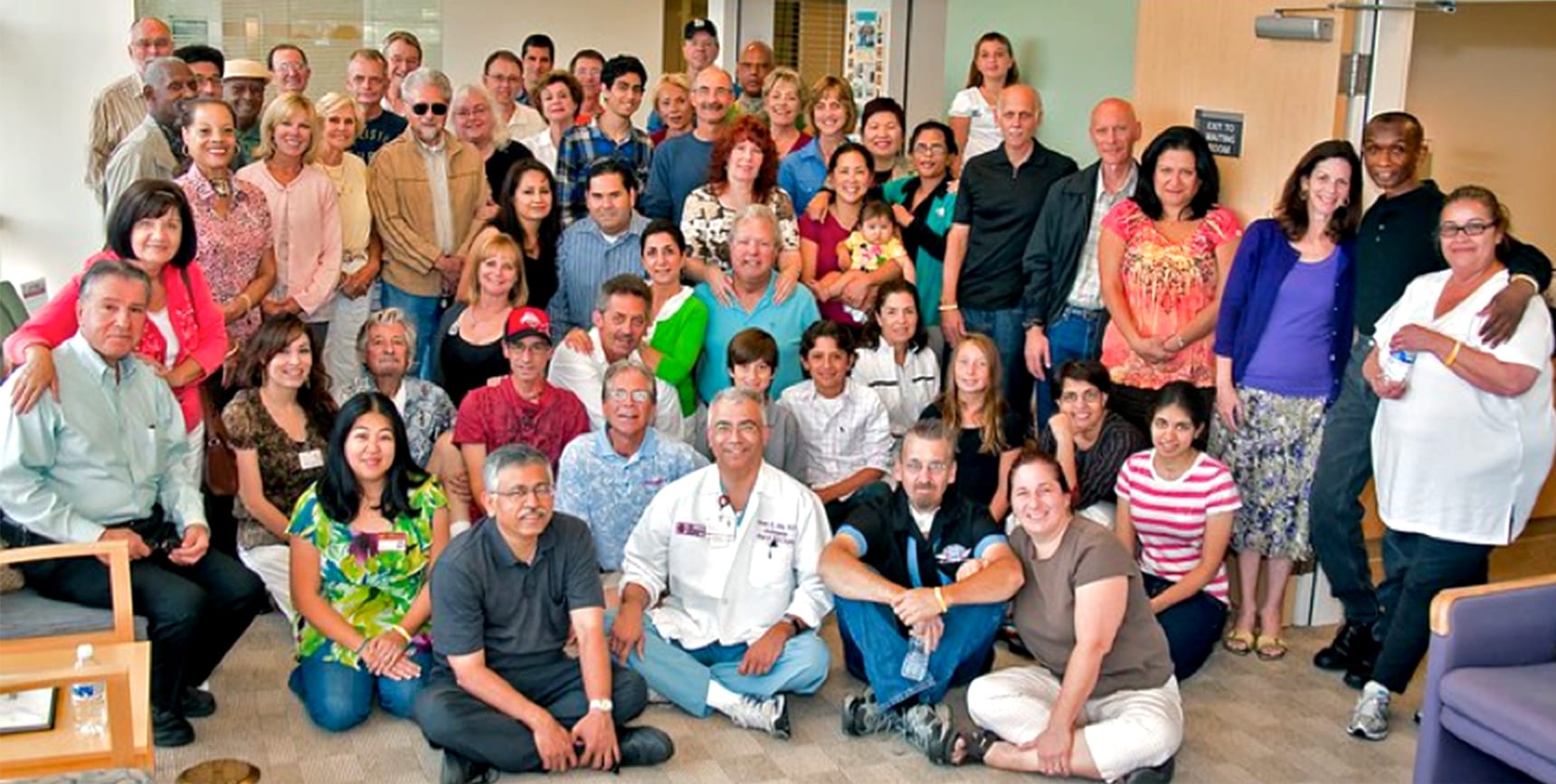 A photo of patients, family members, and clinical staff attending a meeting of the head and neck cancer support group.